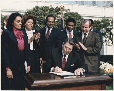 1768838444062_751px Photograph_of_President_Reagan_and_the_Signing_Ceremony_for_Martin_Luther_King_Holiday_Legislation